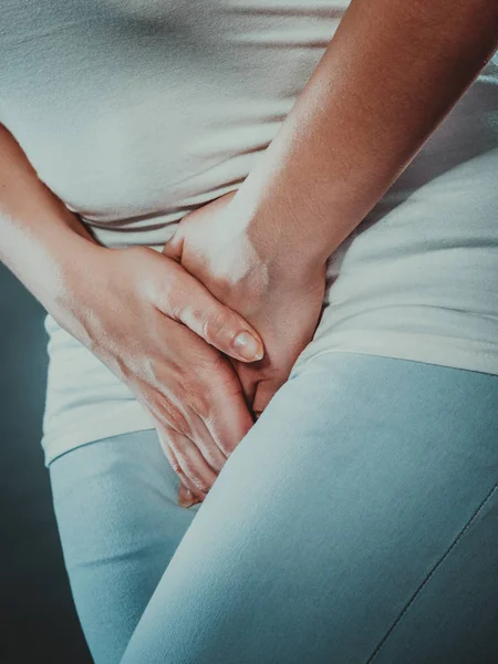 Woman with hands holding her crotch — Stock Image Woman with hands holding her crotch Royalty Free Stock Images