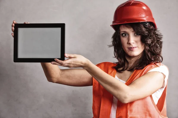Sexy chica en casco de seguridad mostrando tableta — Foto de Stock