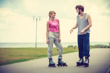 Çift birbirine bakarak rollerskates giyiyor
