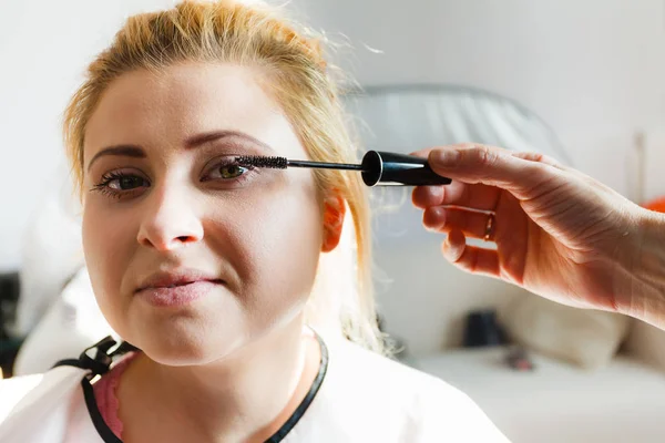 Mujer conseguir pestañas maquillaje hecho —  Fotos de Stock