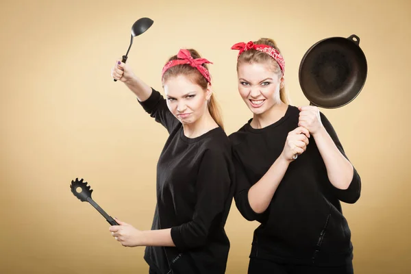 Retro styled women having fun with kitchen accessories. — Stock Photo, Image