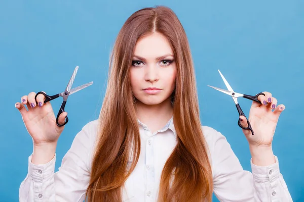 Professional hairdresser dual wielding scissors.