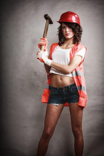 Sexy girl in safety helmet holding hammer tool — Stock Photo, Image