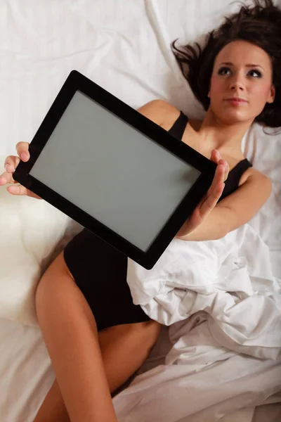 Sexy ragazza pigra sdraiata con tablet touchpad sul letto — Foto Stock