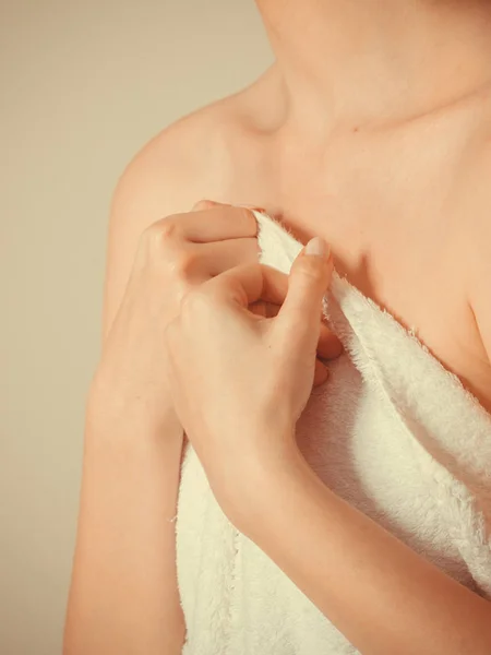 Woman covering breast under towel.