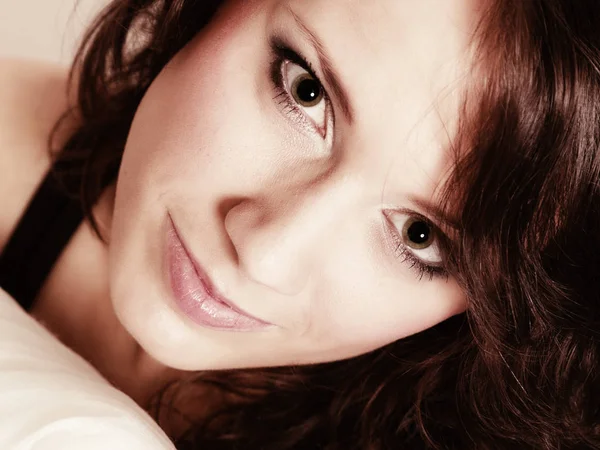 Portrait girl with pillow. Woman with curly hair — Stock Photo, Image