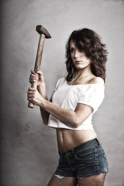 Sexy girl repairman holding hammer tool — Stock Photo, Image