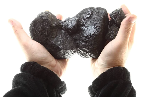 Pezzi di carbone in mano isolati su fondo bianco — Foto Stock
