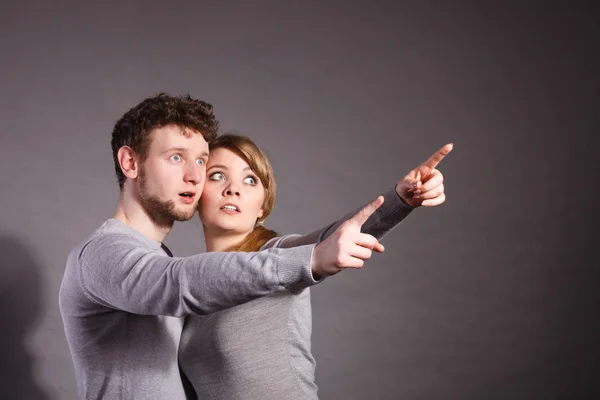 Verängstigtes junges Paar zeigt Kopierraum. — Stockfoto