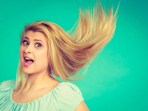 Shocked amazed blonde woman with crazy windblown hair — Stock Photo, Image