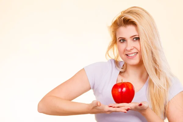 Happy woman holding delicious red apple — Stock Photo, Image