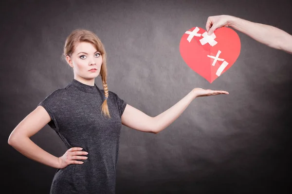 Trauriges Paar hält gebrochenes Herz. — Stockfoto