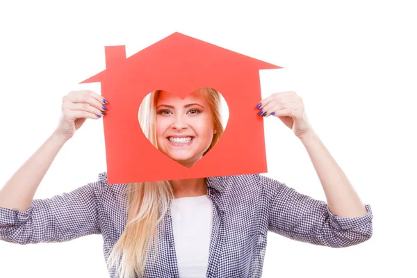 Smiling girl holding red paper house with heart shape — Stock Photo, Image