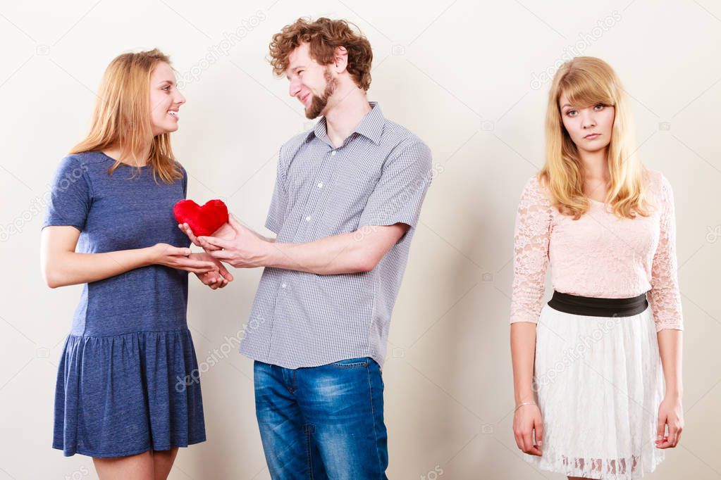 Abandoned woman with enamored couple