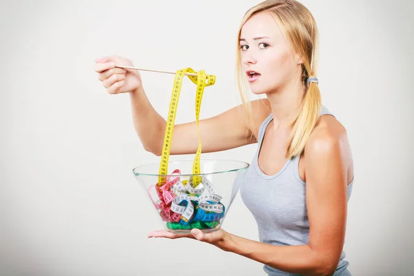 Diet. Girl with colorful measuring tapes in bowl — Stock Photo, Image