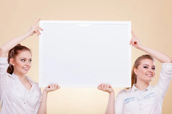 Two girls with blank presentation board — Stock Photo, Image