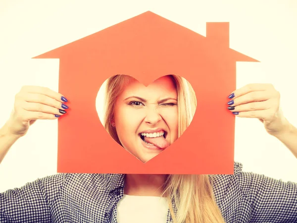 Happy woman holding red paper house — Stock Photo, Image