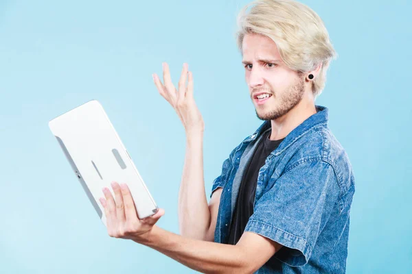 Trendy young man using tablet thinking — Stock Photo, Image