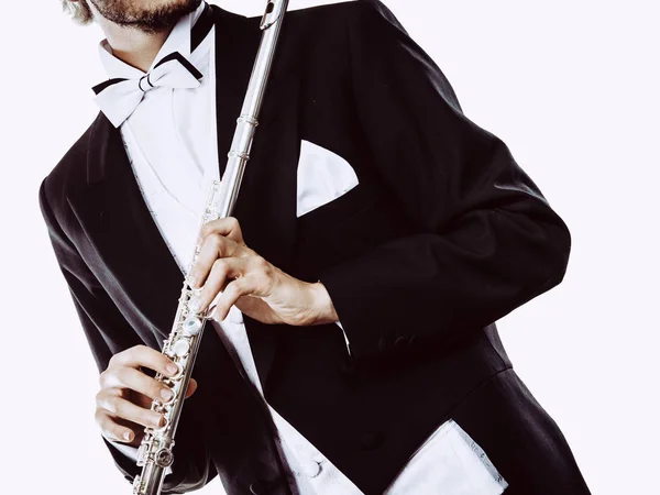 Male flutist wearing tailcoat holds flute — Stock Photo, Image