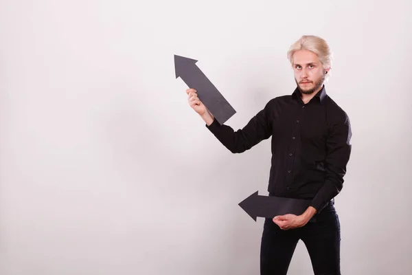 Man holding two arrows pointing same direction — Stock Photo, Image