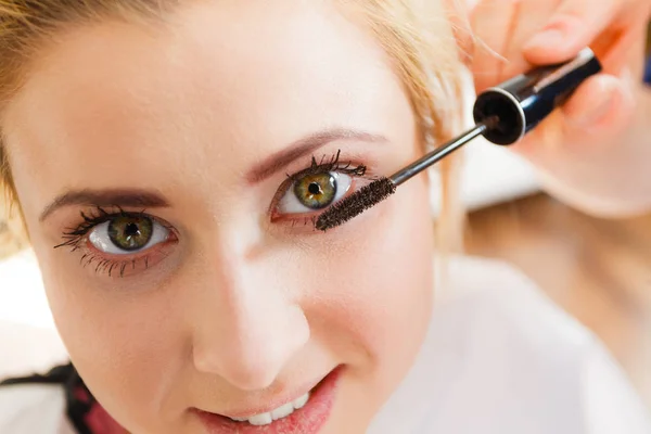 Vrouw wimpers make-up gedaan krijgen — Stockfoto