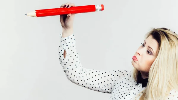 Woman confused drawing with big pencil — Stock Photo, Image