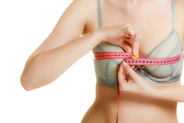 Woman in bra lingerie measuring her chest breasts. — Stock Photo, Image