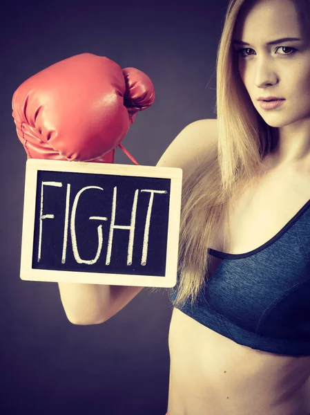 Woman wearing boxing glove holding fight sign — Stock Photo, Image