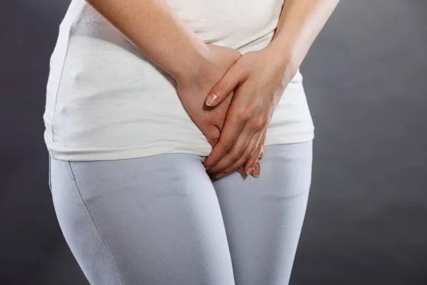 Woman with hands holding her crotch — Stock Photo, Image
