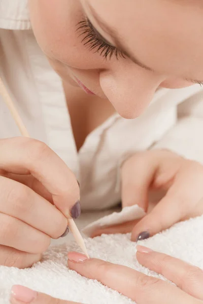 Kosmetikerin präpariert Nägel vor Maniküre, schiebt Nagelhaut zurück — Stockfoto