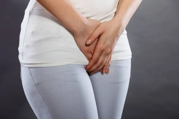Woman with hands holding her crotch — Stock Image Woman with hands holding her crotch Stock Picture