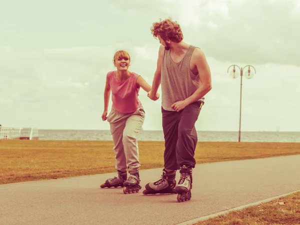 Hombre animar a la mujer a hacer patinaje — Foto de Stock