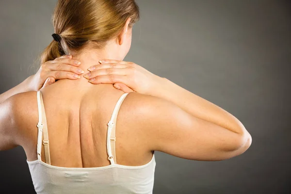 Woman suffering from neck pain Stock Picture