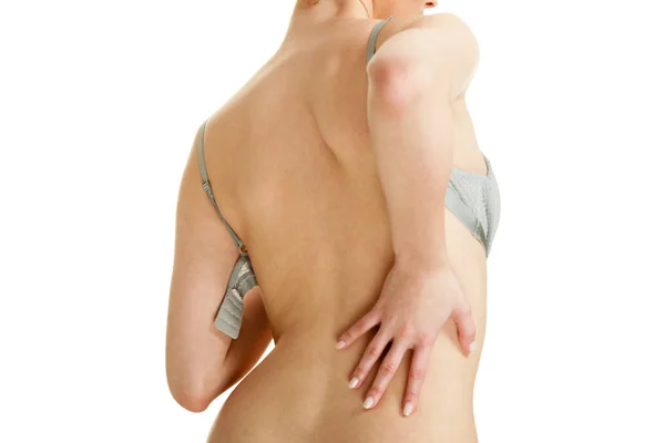 Attraktiv smal kvinna lyfter grå BH — Stockfoto