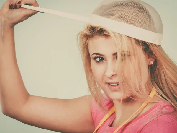 Blonde woman wearing colander on head — Stock Photo, Image