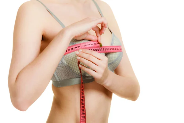 Woman in bra lingerie measuring her chest breasts. — Stock Photo, Image