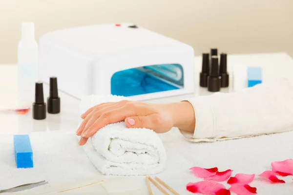 Woman hand on towel, next to manicure set — Stock Photo, Image