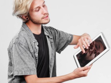 Tablet bilgisayar kullanan trendy genç adam