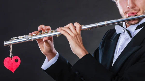 Male flutist with flute and heart. Love melody — Stock Photo, Image