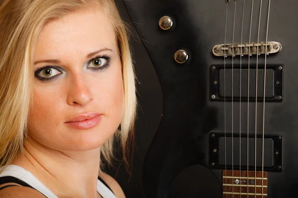 Blond vrouw met elektrische gitaar, zwarte achtergrond — Stockfoto