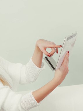 Kredi kartı tutan tablet kullanan kadın