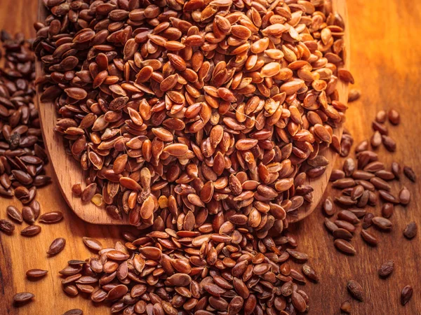 Flax seeds linseed on wooden spoon — Stock Photo, Image