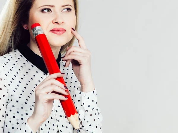 Woman confused thinking, big pencil in hand — Stock Photo, Image