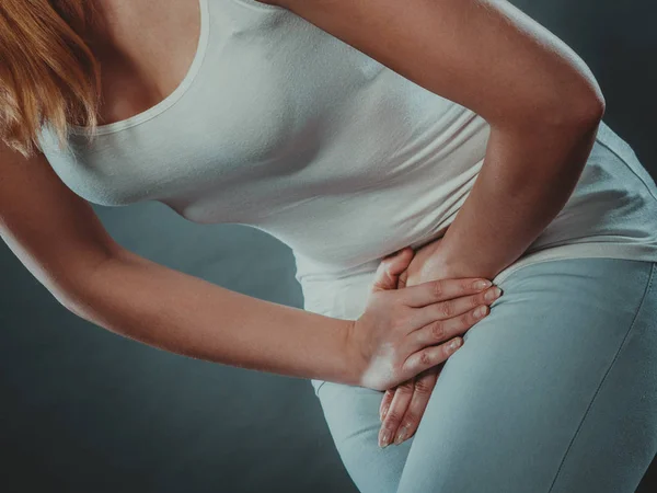 Woman with hands holding her crotch — Stock Image Woman with hands holding her crotch Stock Picture