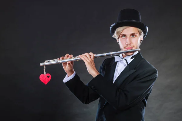 Male flutist with flute and heart. Love melody — Stock Photo, Image