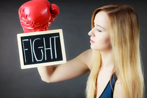 Woman wearing boxing glove holding fight sign — Stock Photo, Image