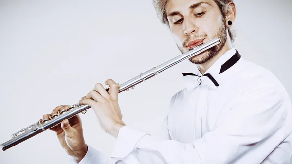 Male flutist playing his flute — Stock Photo, Image