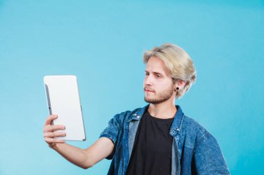 Tablet bilgisayar kullanarak trendy genç adam