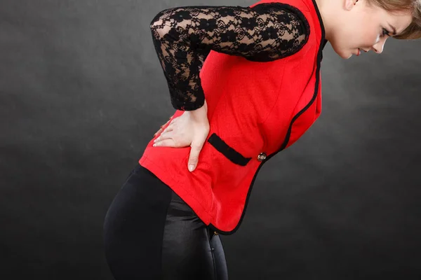 Woman in elegant clothes having back pain — Stock Photo, Image