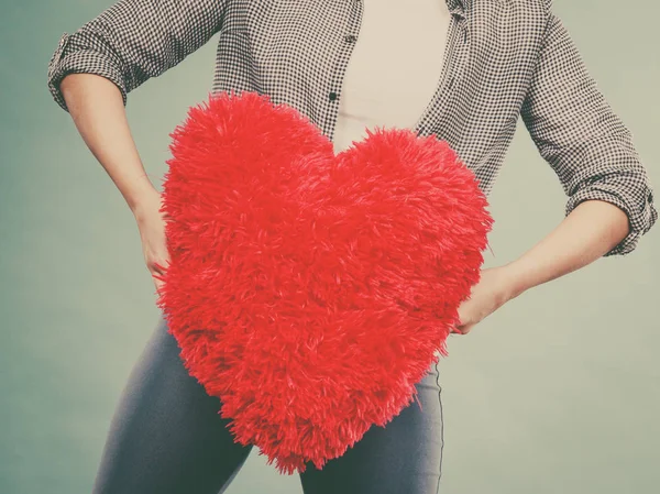 Mujer sosteniendo almohada roja en forma de corazón —  Fotos de Stock